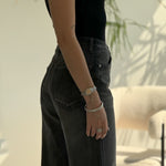 high-waisted black wide-leg jeans.