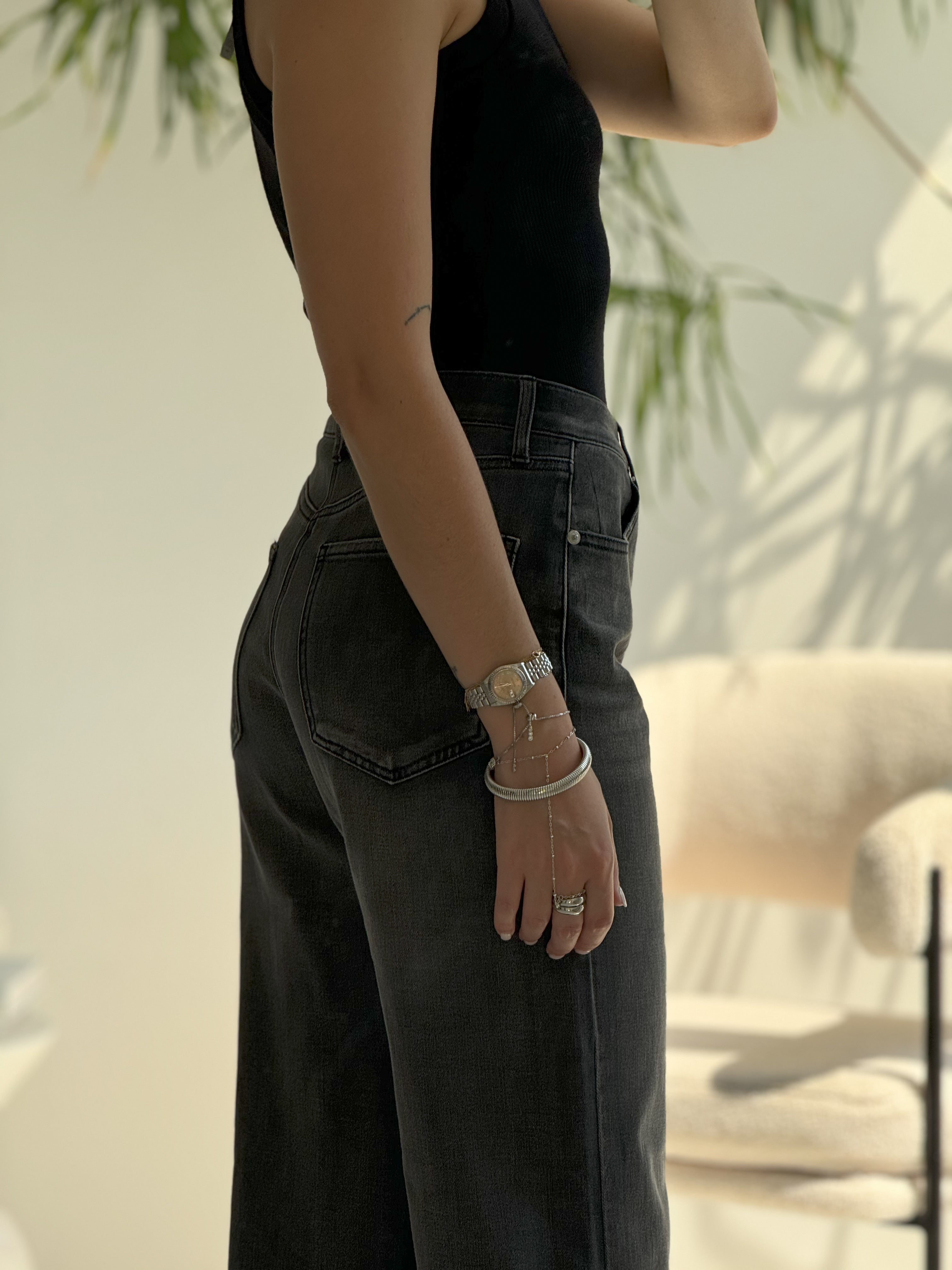 high-waisted black wide-leg jeans.